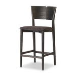 Inspired by simple Scandinavian styling, a dark-finished parawood stool's slit-back metal inlay adds a decorative touch. Easy curves from bent wood give a smooth silhouette. Sized for the counter and upholstered with a thin seat cushion upholstered in black performance fabric, perfect for dining or entertaining. Amethyst Home provides interior design, new home construction design consulting, vintage area rugs, and lighting in the Des Moines metro area.