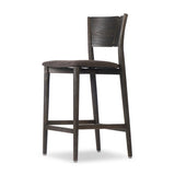 Inspired by simple Scandinavian styling, a dark-finished parawood stool's slit-back metal inlay adds a decorative touch. Easy curves from bent wood give a smooth silhouette. Sized for the counter and upholstered with a thin seat cushion upholstered in black performance fabric, perfect for dining or entertaining. Amethyst Home provides interior design, new home construction design consulting, vintage area rugs, and lighting in the Nashville metro area.