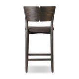 Inspired by simple Scandinavian styling, a dark-finished parawood stool's slit-back metal inlay adds a decorative touch. Easy curves from bent wood give a smooth silhouette. Sized for the counter and upholstered with a thin seat cushion upholstered in black performance fabric, perfect for dining or entertaining. Amethyst Home provides interior design, new home construction design consulting, vintage area rugs, and lighting in the Park City metro area.