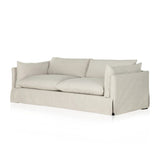 A slipcovered sofa made for modern living. Shelter arms and big, pillow-inspired cushions are covered in a durable comfortable fabric prime for lounging. Performance fabrics are specially created to withstand spills, stains, high traffic and wear, ensuring long-term comfort and unmatched durability Amethyst Home provides interior design, new home construction design consulting, vintage area rugs, and lighting in the Alpharetta metro area.