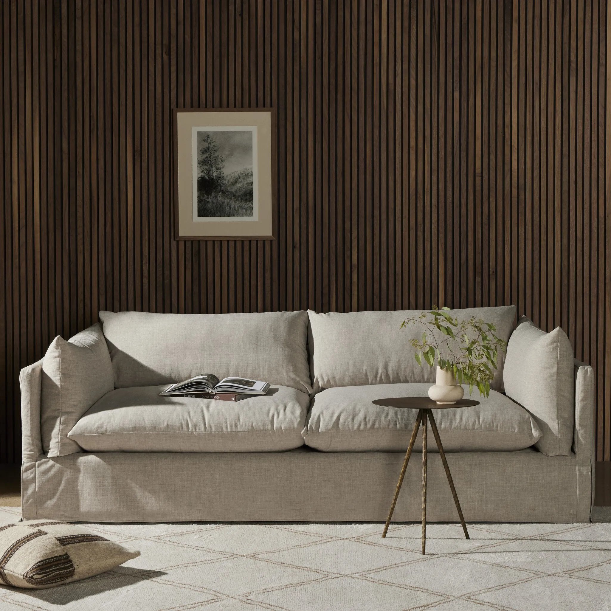 A slipcovered sofa made for modern living. Shelter arms and big, pillow-inspired cushions are covered in a durable comfortable fabric prime for lounging. Performance fabrics are specially created to withstand spills, stains, high traffic and wear, ensuring long-term comfort and unmatched durability Amethyst Home provides interior design, new home construction design consulting, vintage area rugs, and lighting in the Los Angeles metro area.