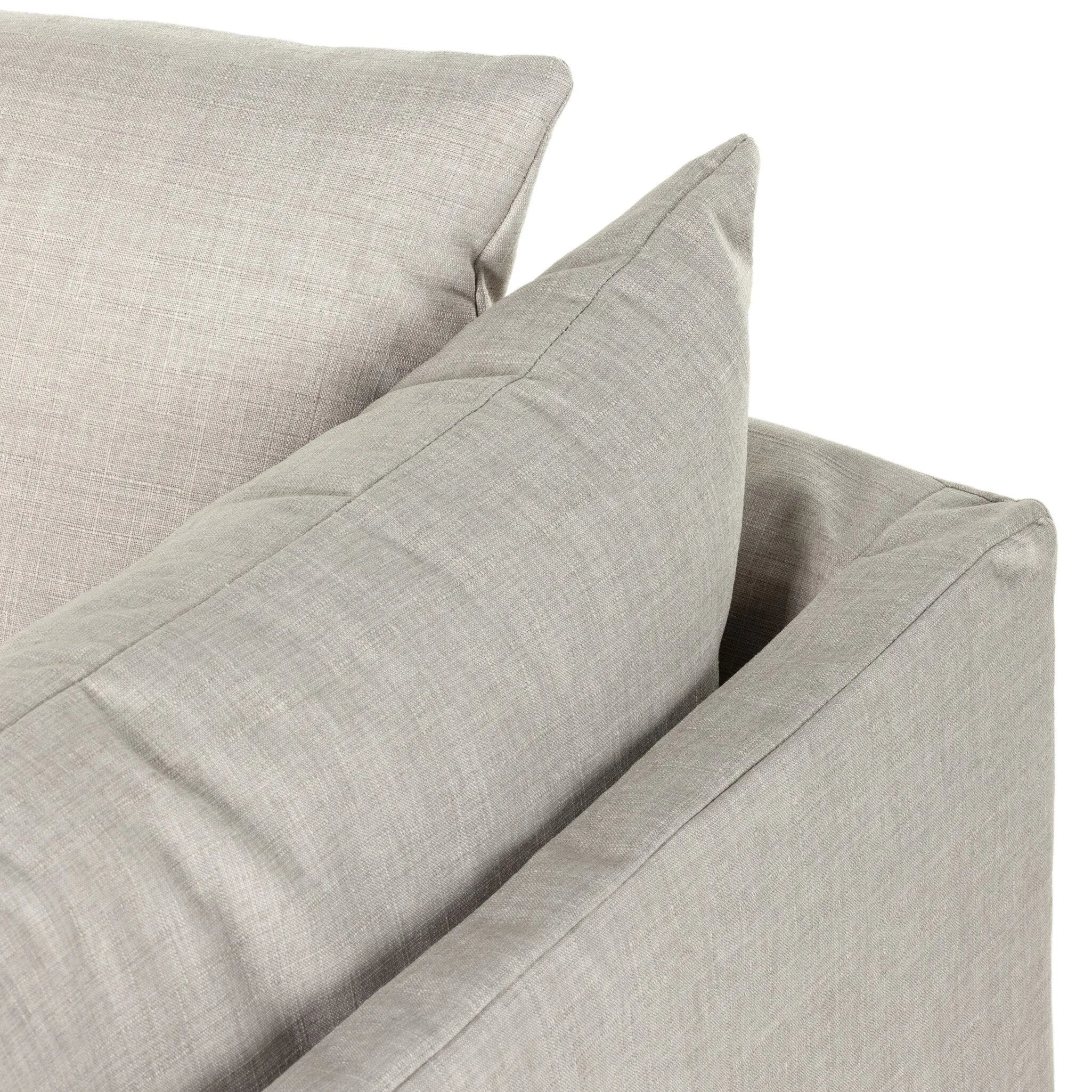 A slipcovered sofa made for modern living. Shelter arms and big, pillow-inspired cushions are covered in a durable comfortable fabric prime for lounging. Performance fabrics are specially created to withstand spills, stains, high traffic and wear, ensuring long-term comfort and unmatched durability Amethyst Home provides interior design, new home construction design consulting, vintage area rugs, and lighting in the Seattle metro area.