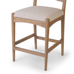 A curved back wrapped and textural woven paper cord take this everyday counter stool to new heights. Natural nettlewood frames a linen-blend seat for a clean look Amethyst Home provides interior design, new home construction design consulting, vintage area rugs, and lighting in the Salt Lake City metro area.