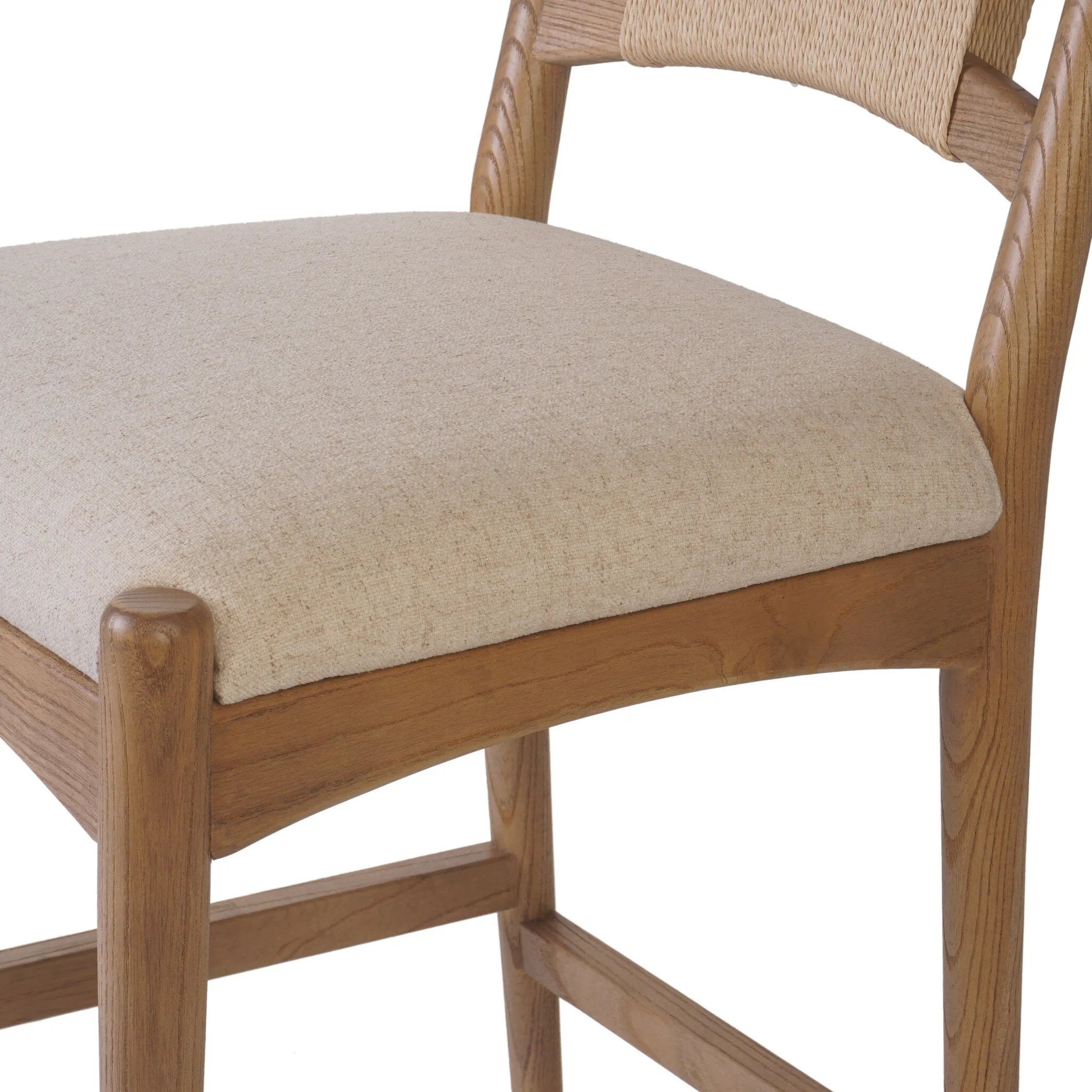 A curved back wrapped and textural woven paper cord take this everyday counter stool to new heights. Natural nettlewood frames a linen-blend seat for a clean look Amethyst Home provides interior design, new home construction design consulting, vintage area rugs, and lighting in the Seattle metro area.