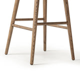 A midcentury-inspired counter stool gets refreshed with a modern memory swivel and chestnut top-grain leather. Slim, tapered oak legs balance a curved seat Amethyst Home provides interior design, new home construction design consulting, vintage area rugs, and lighting in the Alpharetta metro area.