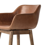 A midcentury-inspired counter stool gets refreshed with a modern memory swivel and chestnut top-grain leather. Slim, tapered oak legs balance a curved seat Amethyst Home provides interior design, new home construction design consulting, vintage area rugs, and lighting in the Calabasas metro area.