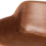 A midcentury-inspired counter stool gets refreshed with a modern memory swivel and chestnut top-grain leather. Slim, tapered oak legs balance a curved seat Amethyst Home provides interior design, new home construction design consulting, vintage area rugs, and lighting in the Des Moines metro area.