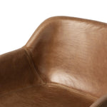 A midcentury-inspired counter stool gets refreshed with a modern memory swivel and chestnut top-grain leather. Slim, tapered oak legs balance a curved seat Amethyst Home provides interior design, new home construction design consulting, vintage area rugs, and lighting in the Monterey metro area.