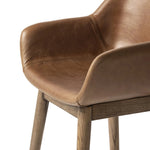 A midcentury-inspired counter stool gets refreshed with a modern memory swivel and chestnut top-grain leather. Slim, tapered oak legs balance a curved seat Amethyst Home provides interior design, new home construction design consulting, vintage area rugs, and lighting in the Newport Beach metro area.