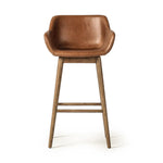 A midcentury-inspired counter stool gets refreshed with a modern memory swivel and chestnut top-grain leather. Slim, tapered oak legs balance a curved seat Amethyst Home provides interior design, new home construction design consulting, vintage area rugs, and lighting in the Omaha metro area.