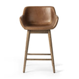 A midcentury-inspired counter stool gets refreshed with a modern memory swivel and chestnut top-grain leather. Slim, tapered oak legs balance a curved seat Amethyst Home provides interior design, new home construction design consulting, vintage area rugs, and lighting in the Winter Garden metro area.