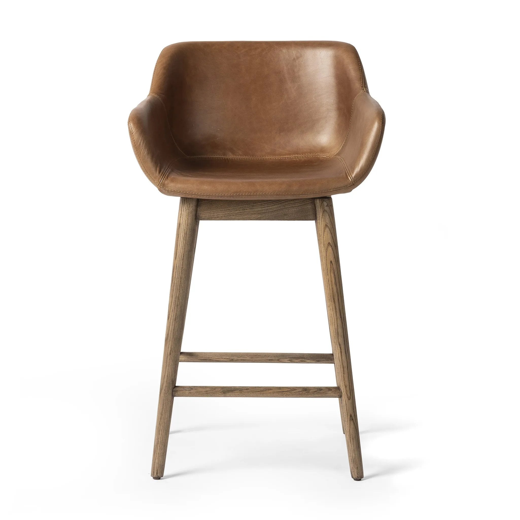 A midcentury-inspired counter stool gets refreshed with a modern memory swivel and chestnut top-grain leather. Slim, tapered oak legs balance a curved seat Amethyst Home provides interior design, new home construction design consulting, vintage area rugs, and lighting in the Winter Garden metro area.