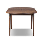 Design with flexibility. Finished in a warm toasted walnut, an oval acacia tabletop, cone-tapered legs and iron detailing speak to Scandinavian modernism. Expansion from 84" to 104" means more space when company calls Amethyst Home provides interior design, new home construction design consulting, vintage area rugs, and lighting in the Austin metro area.
