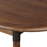 Design with flexibility. Finished in a warm toasted walnut, an oval acacia tabletop, cone-tapered legs and iron detailing speak to Scandinavian modernism. Expansion from 84" to 104" means more space when company calls Amethyst Home provides interior design, new home construction design consulting, vintage area rugs, and lighting in the Calabasas metro area.