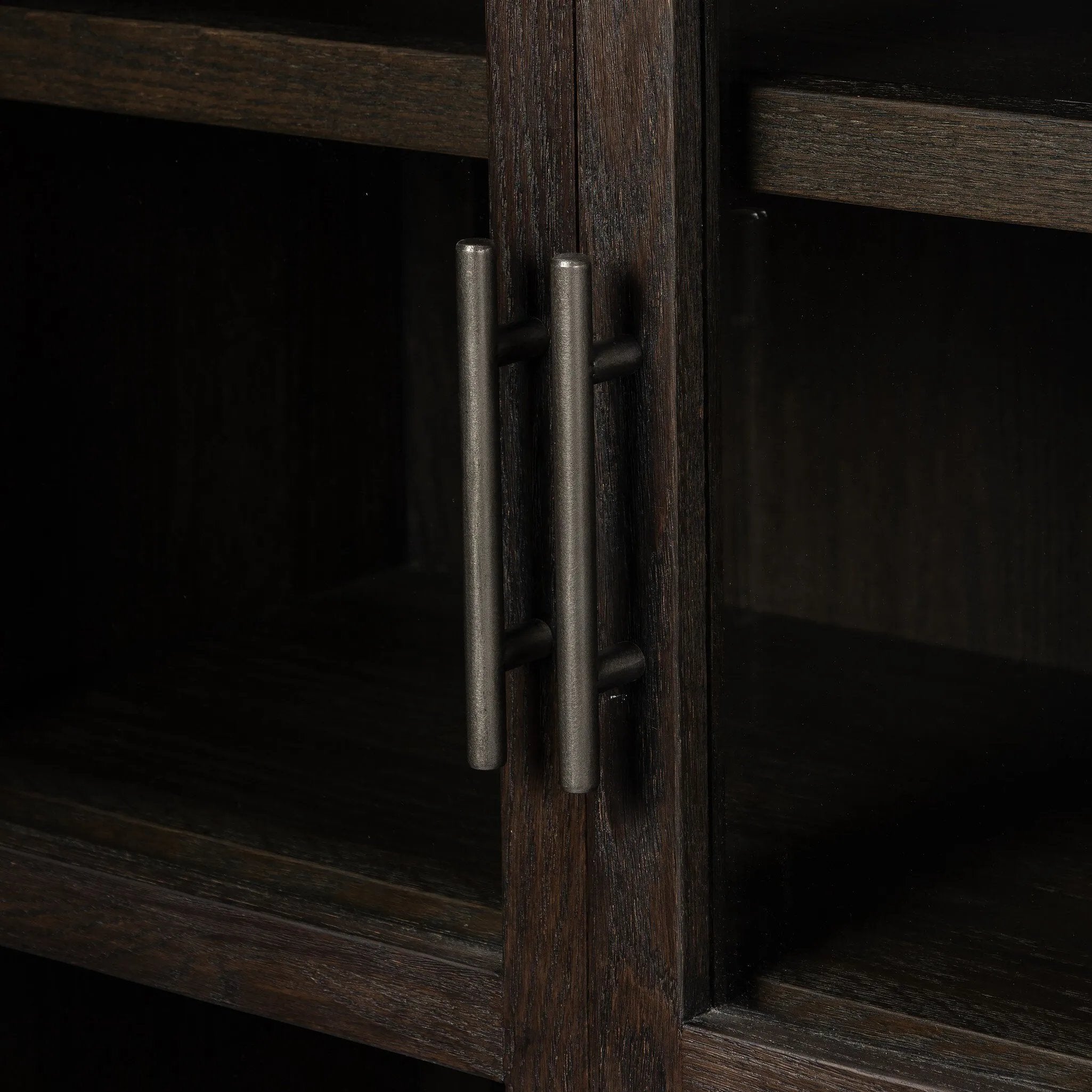 Featuring Hepburn Dark Anthracite Oak Veneer Cabinet by Four Hands at Amethyst Home. Beautifully arched with a flush plinth base, a versatile oak cabinet features a dark, rich finish. With generous interior shelving, a tempered glass front allows you to showcase favorite books and treasures — letting anyone who enters your space know exactly who you are. Ov. Amethyst Home provides interior design, new home construction design consulting, vintage area rugs, and lighting in the San Diego metro area.