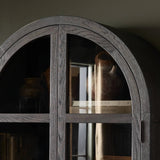 Featuring Hepburn Dark Anthracite Oak Veneer Cabinet by Four Hands at Amethyst Home. Beautifully arched with a flush plinth base, a versatile oak cabinet features a dark, rich finish. With generous interior shelving, a tempered glass front allows you to showcase favorite books and treasures — letting anyone who enters your space know exactly who you are. O. Amethyst Home provides interior design, new home construction design consulting, vintage area rugs, and lighting in the Washington metro area.