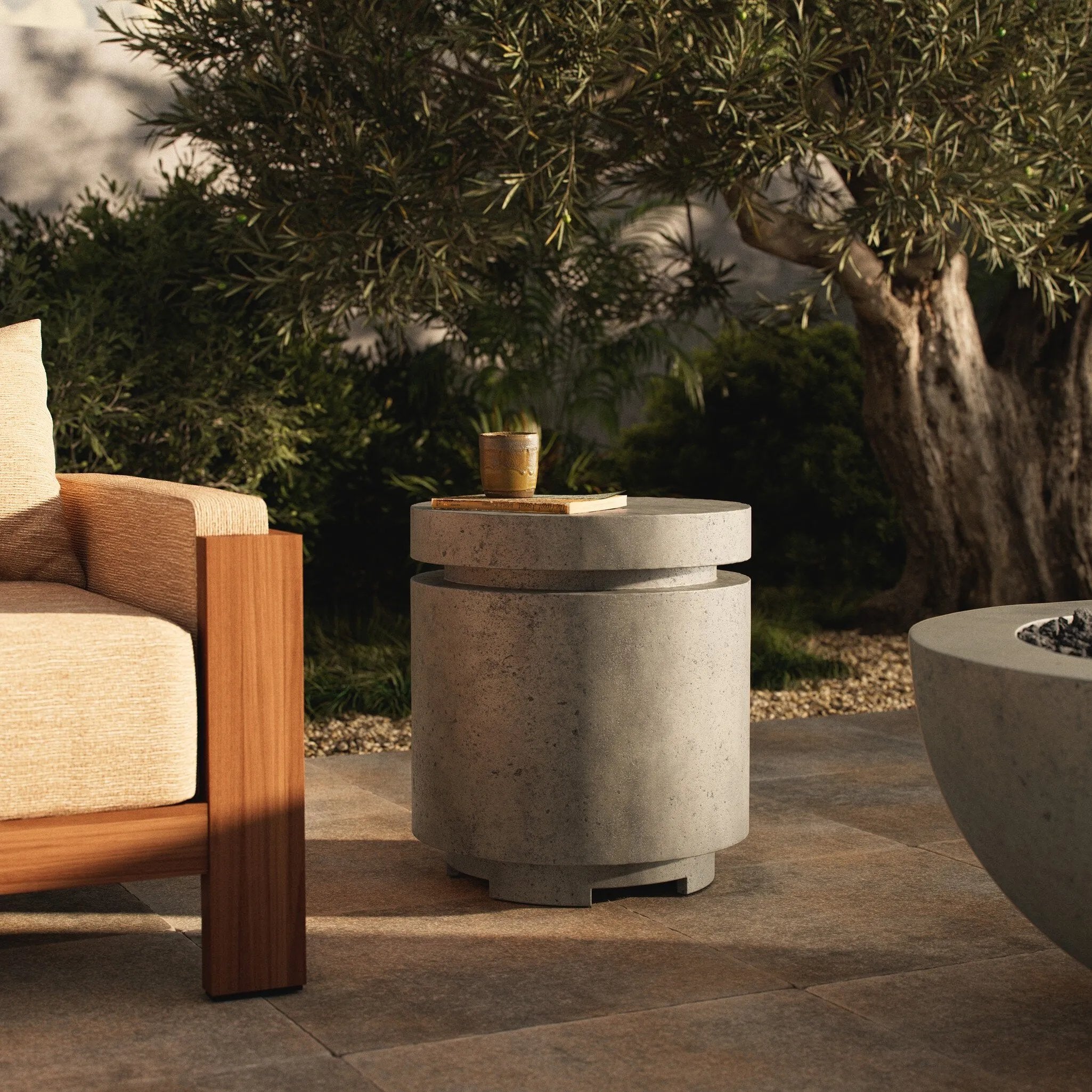 This outdoor propane tank enclosure pairs with fire tables for a clean, seamless look. Made from glass-reinforced concrete, each piece is naturally finished with deep tones of pewter and dark grey. It can act as an end table with its lid on, and has cutouts at the base for hose attachments. Amethyst Home provides interior design, new home construction design consulting, vintage area rugs, and lighting in the Monterey metro area.