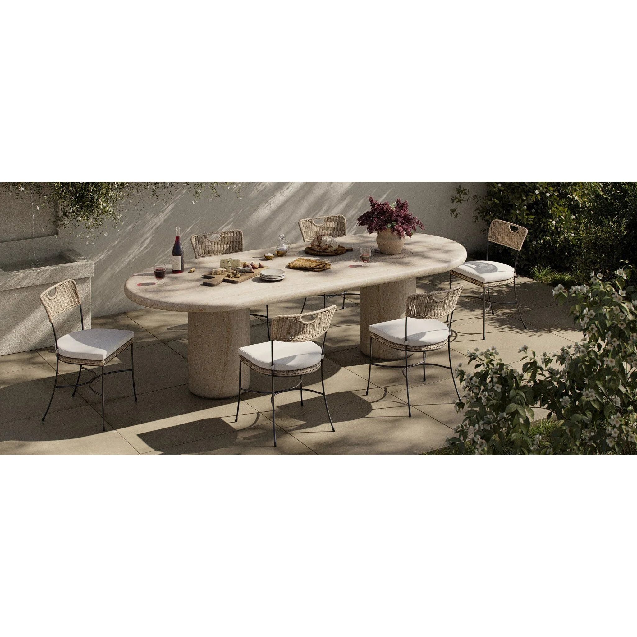A light, airy take on the traditional bistro shape. This outdoor dining chair features exaggerated splayed legs and a curved X-shaped stretcher, with a handle detail cut out of the woven seat back. Finished with a seat cushion. Cover or store indoors during inclement weather and when not in use. Amethyst Home provides interior design, new home construction design consulting, vintage area rugs, and lighting in the Portland metro area.