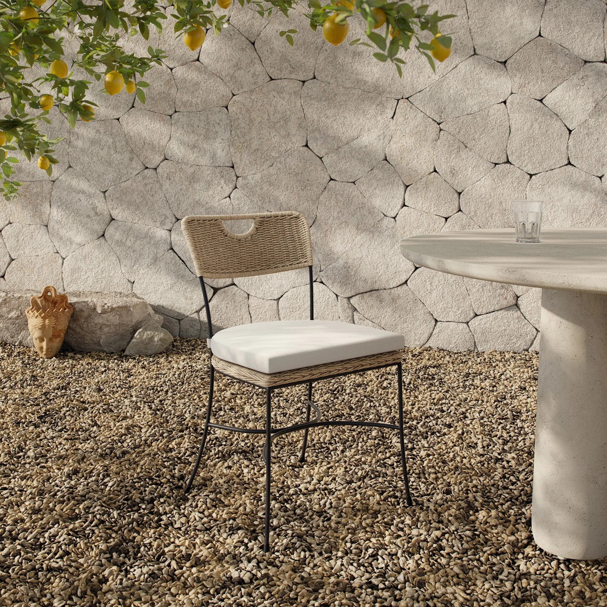 A light, airy take on the traditional bistro shape. This outdoor dining chair features exaggerated splayed legs and a curved X-shaped stretcher, with a handle detail cut out of the woven seat back. Finished with a seat cushion. Cover or store indoors during inclement weather and when not in use. Amethyst Home provides interior design, new home construction design consulting, vintage area rugs, and lighting in the San Diego metro area.