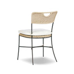 A light, airy take on the traditional bistro shape. This outdoor dining chair features exaggerated splayed legs and a curved X-shaped stretcher, with a handle detail cut out of the woven seat back. Finished with a seat cushion. Cover or store indoors during inclement weather and when not in use. Amethyst Home provides interior design, new home construction design consulting, vintage area rugs, and lighting in the Scottsdale metro area.