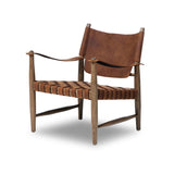 Featuring Ignacio Renault Cognac Chair by Four Hands at Amethyst Home. Reviving a vintage-inspired frame, this leather sling chair meets retro character with laid-back comfort. The tan leather sling back, shaped like a shield, adds bold style, while the woven seat provides a supportive, unique seating experience. Crafted from an ash wood frame with dowel cons. Amethyst Home provides interior design, new home construction design consulting, vintage area rugs, and lighting in the Houston metro area.