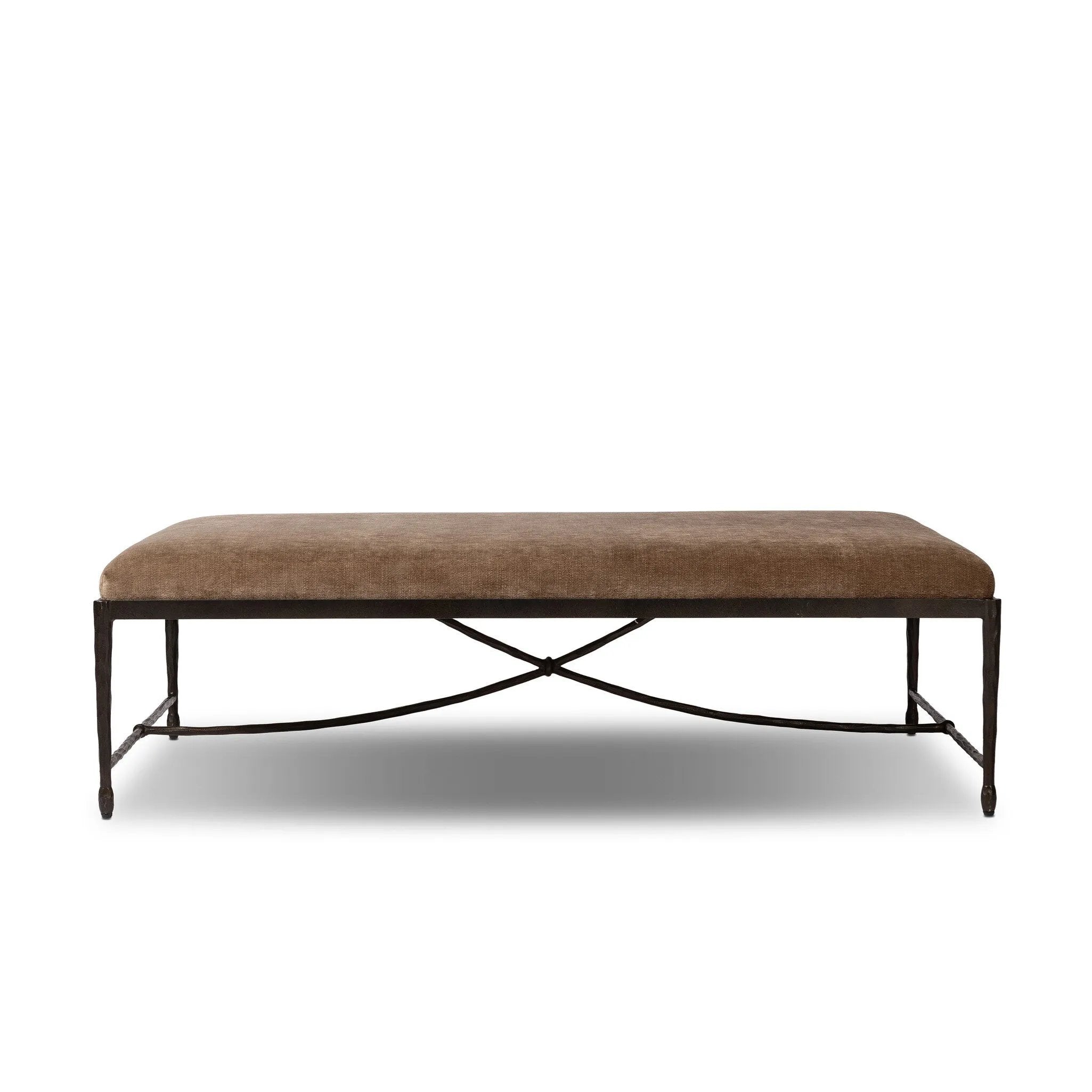 This French Industrialist-inspired cocktail ottoman features a curved stretcher base of bronzed hammered iron and a velvety seat in a versatile earth tone. Style with a sofa or sectional to create an extra surface in your living space, or for bonus seating. Amethyst Home provides interior design, new home construction design consulting, vintage area rugs, and lighting in the Houston metro area.