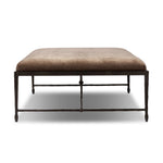 This French Industrialist-inspired cocktail ottoman features a curved stretcher base of bronzed hammered iron and a velvety seat in a versatile earth tone. Style with a sofa or sectional to create an extra surface in your living space, or for bonus seating. Amethyst Home provides interior design, new home construction design consulting, vintage area rugs, and lighting in the Winter Garden metro area.