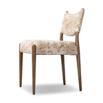 A midcentury-inspired piece brought to modern times. A supportive, sling-style back and seat cushion are upholstered in a soft, velvety fabric, with toasted oak armless framing Amethyst Home provides interior design, new home construction design consulting, vintage area rugs, and lighting in the Austin metro area.