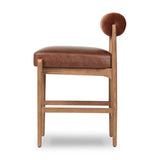 Featuring Jazelle Altair Sienna Counter Stool by Four Hands at Amethyst Home. The classic counter stool gets a playful update with a bolstered cylinder seat back. Made from top-grain leather and warm-finished oak to elevate your bar, kitchen or dining space. Overall Dimensions: 22.25"w x 25.75"d x 36.50"h. Amethyst Home provides interior design, new home construction design consulting, vintage area rugs, and lighting in the Portland metro area.