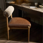 Featuring Jazelle Taupe Shearling Dining Chair by Four Hands at Amethyst Home. The armless dining chair gets a playful update with mixed materials and a bolstered cylinder seat back. Inspired by midcentury and Seventies styling and made from solid oak, top-grain leather  and soft shearling to elevate your bar, kitchen or dining space. Overall Dimensions: 2. Amethyst Home provides interior design, new home construction design consulting, vintage area rugs, and lighting in the Alpharetta metro area.