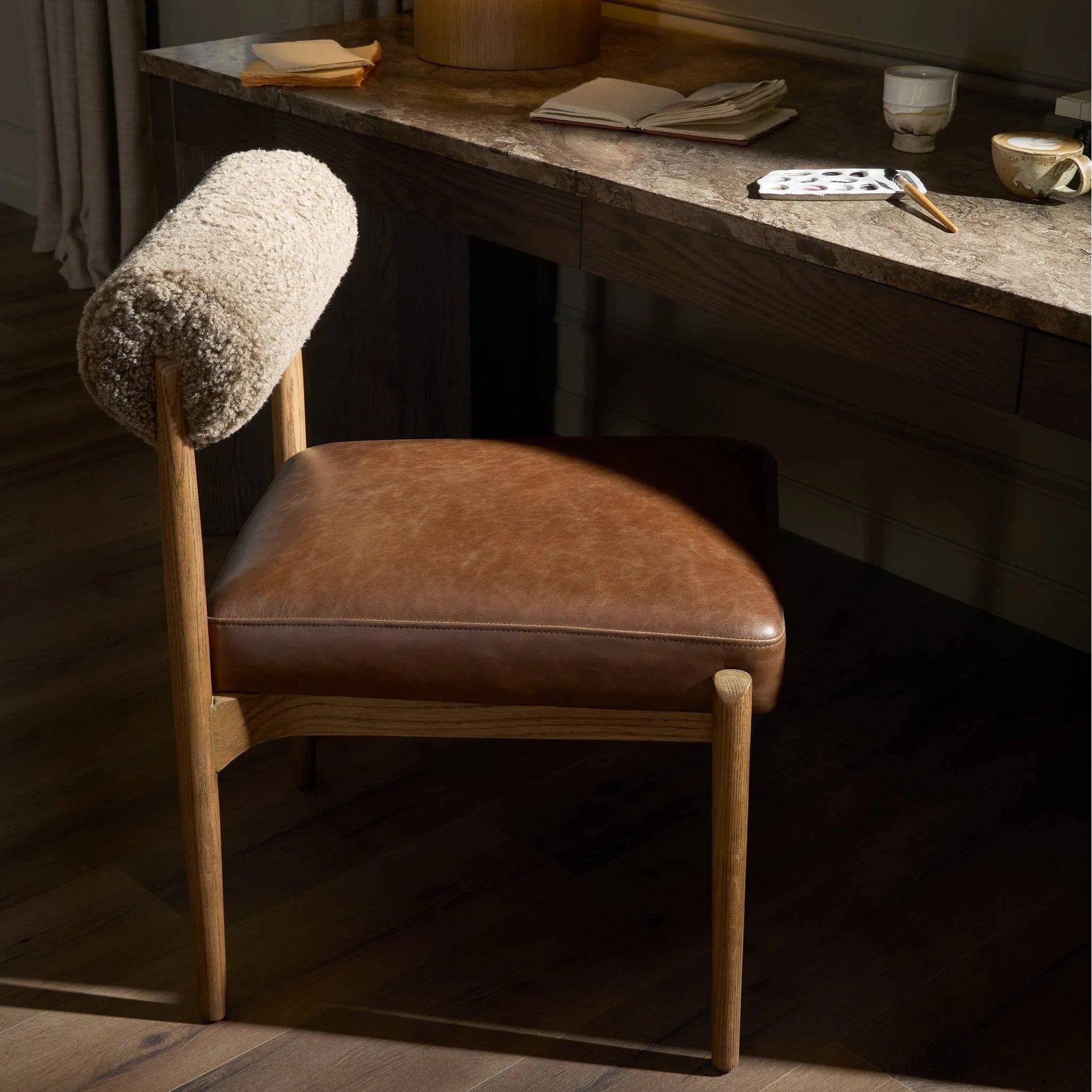 Featuring Jazelle Taupe Shearling Dining Chair by Four Hands at Amethyst Home. The armless dining chair gets a playful update with mixed materials and a bolstered cylinder seat back. Inspired by midcentury and Seventies styling and made from solid oak, top-grain leather  and soft shearling to elevate your bar, kitchen or dining space. Overall Dimensions: 2. Amethyst Home provides interior design, new home construction design consulting, vintage area rugs, and lighting in the Alpharetta metro area.