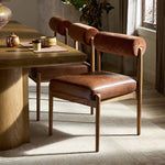 Featuring Jazelle Altair Sienna Dining Chair by Four Hands at Amethyst Home. The armless dining chair gets a playful update with a bolstered cylinder seat back. Made from top-grain leather and warm-finished oak to elevate your bar, kitchen or dining space. Overall Dimensions: 22.25"w x 25.75"d x 32.25"h. Amethyst Home provides interior design, new home construction design consulting, vintage area rugs, and lighting in the Calabasas metro area.
