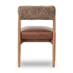Featuring Jazelle Taupe Shearling Dining Chair by Four Hands at Amethyst Home. The armless dining chair gets a playful update with mixed materials and a bolstered cylinder seat back. Inspired by midcentury and Seventies styling and made from solid oak, top-grain leather  and soft shearling to elevate your bar, kitchen or dining space. Overall Dimensions: 22.25. Amethyst Home provides interior design, new home construction design consulting, vintage area rugs, and lighting in the Dallas metro area.
