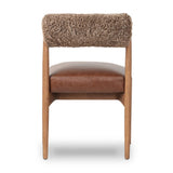 Featuring Jazelle Taupe Shearling Dining Chair by Four Hands at Amethyst Home. The armless dining chair gets a playful update with mixed materials and a bolstered cylinder seat back. Inspired by midcentury and Seventies styling and made from solid oak, top-grain leather  and soft shearling to elevate your bar, kitchen or dining space. Overall Dimensions: 22.25. Amethyst Home provides interior design, new home construction design consulting, vintage area rugs, and lighting in the Dallas metro area.
