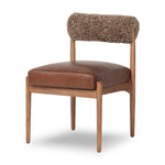 Featuring Jazelle Taupe Shearling Dining Chair by Four Hands at Amethyst Home. The armless dining chair gets a playful update with mixed materials and a bolstered cylinder seat back. Inspired by midcentury and Seventies styling and made from solid oak, top-grain leather  and soft shearling to elevate your bar, kitchen or dining space. Overall Dimensions: 22.25". Amethyst Home provides interior design, new home construction design consulting, vintage area rugs, and lighting in the Omaha metro area.