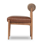 Featuring Jazelle Taupe Shearling Dining Chair by Four Hands at Amethyst Home. The armless dining chair gets a playful update with mixed materials and a bolstered cylinder seat back. Inspired by midcentury and Seventies styling and made from solid oak, top-grain leather  and soft shearling to elevate your bar, kitchen or dining space. Overall Dimensions: 22.25". Amethyst Home provides interior design, new home construction design consulting, vintage area rugs, and lighting in the Tampa metro area.