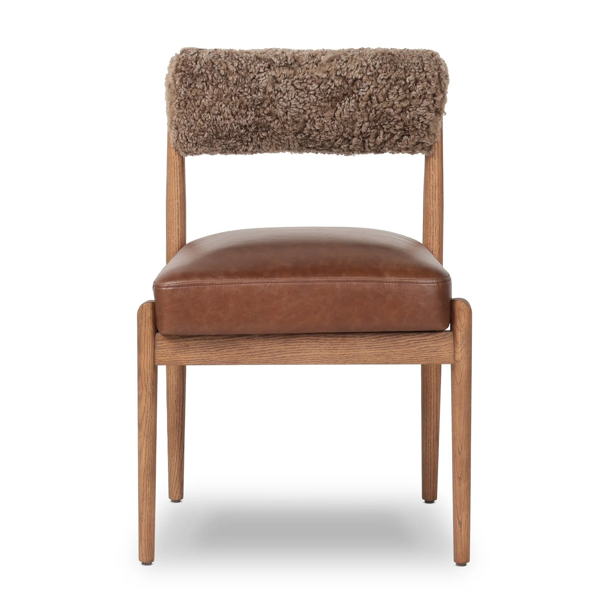 Featuring Jazelle Taupe Shearling Dining Chair by Four Hands at Amethyst Home. The armless dining chair gets a playful update with mixed materials and a bolstered cylinder seat back. Inspired by midcentury and Seventies styling and made from solid oak, top-grain leather  and soft shearling to elevate your bar, kitchen or dining space. Overall Dimensions. Amethyst Home provides interior design, new home construction design consulting, vintage area rugs, and lighting in the Winter Garden metro area.