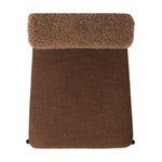 The armless dining chair gets a playful update with a bolstered cylinder seat back. Made from soft shearling and hammered met