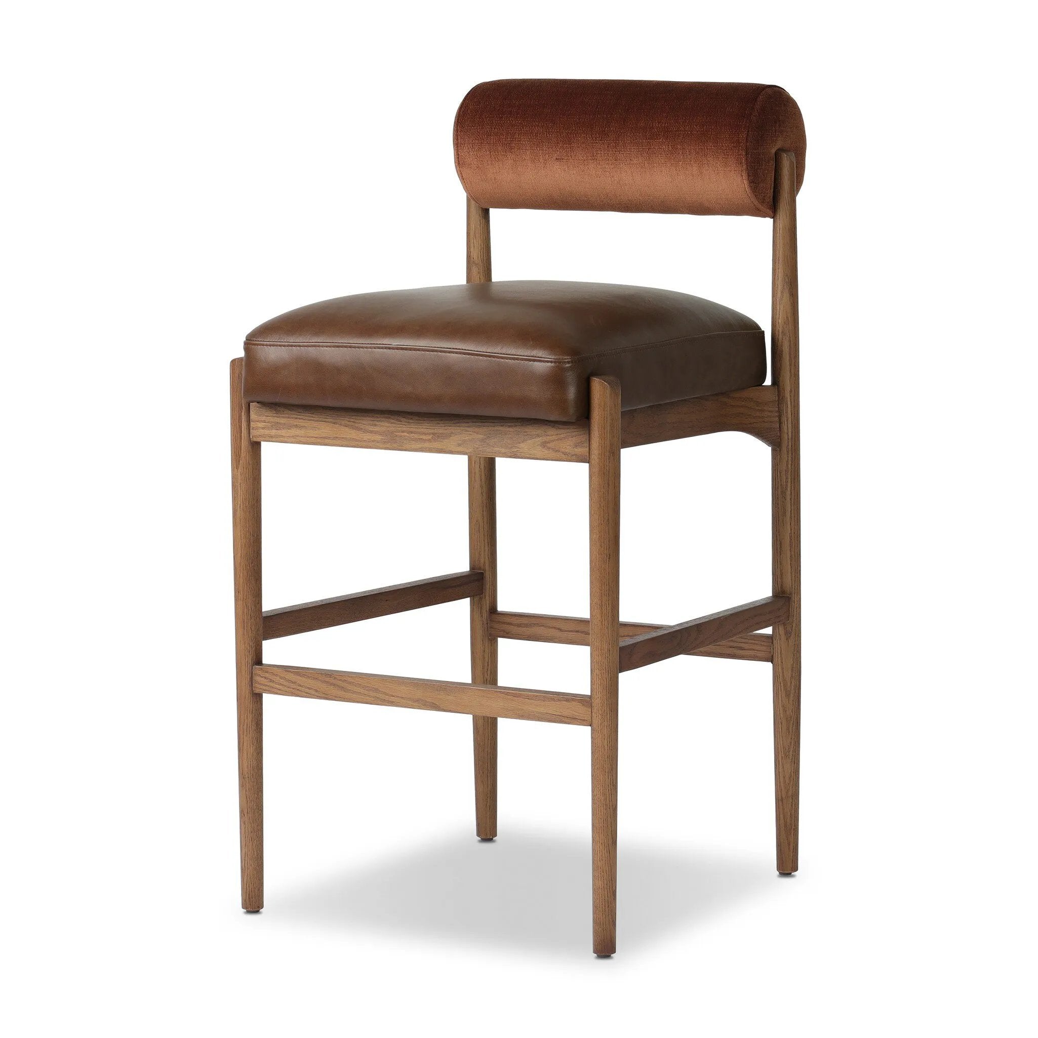 The classic counter stool gets a playful update with a bolstered cylinder seat back. Made from top-grain leather, velvet-like upholstery and warm-finished oak to elevate your bar, kitchen or dining space Amethyst Home provides interior design, new home construction design consulting, vintage area rugs, and lighting in the Nashville metro area.