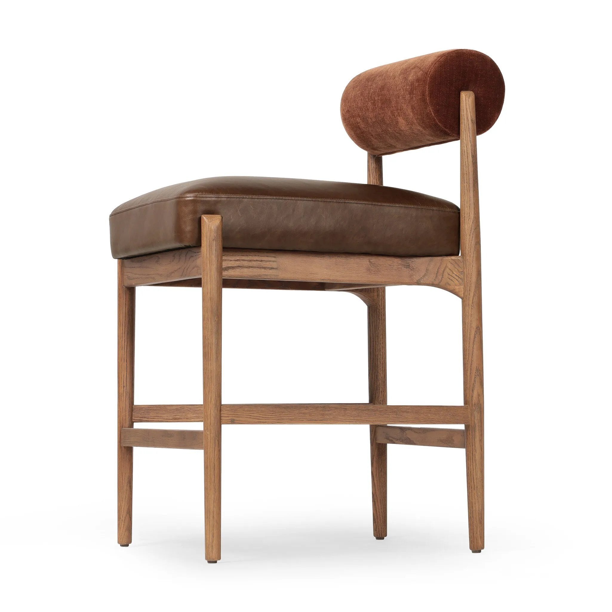 The classic counter stool gets a playful update with a bolstered cylinder seat back. Made from top-grain leather, velvet-like upholstery and warm-finished oak to elevate your bar, kitchen or dining space Amethyst Home provides interior design, new home construction design consulting, vintage area rugs, and lighting in the Park City metro area.