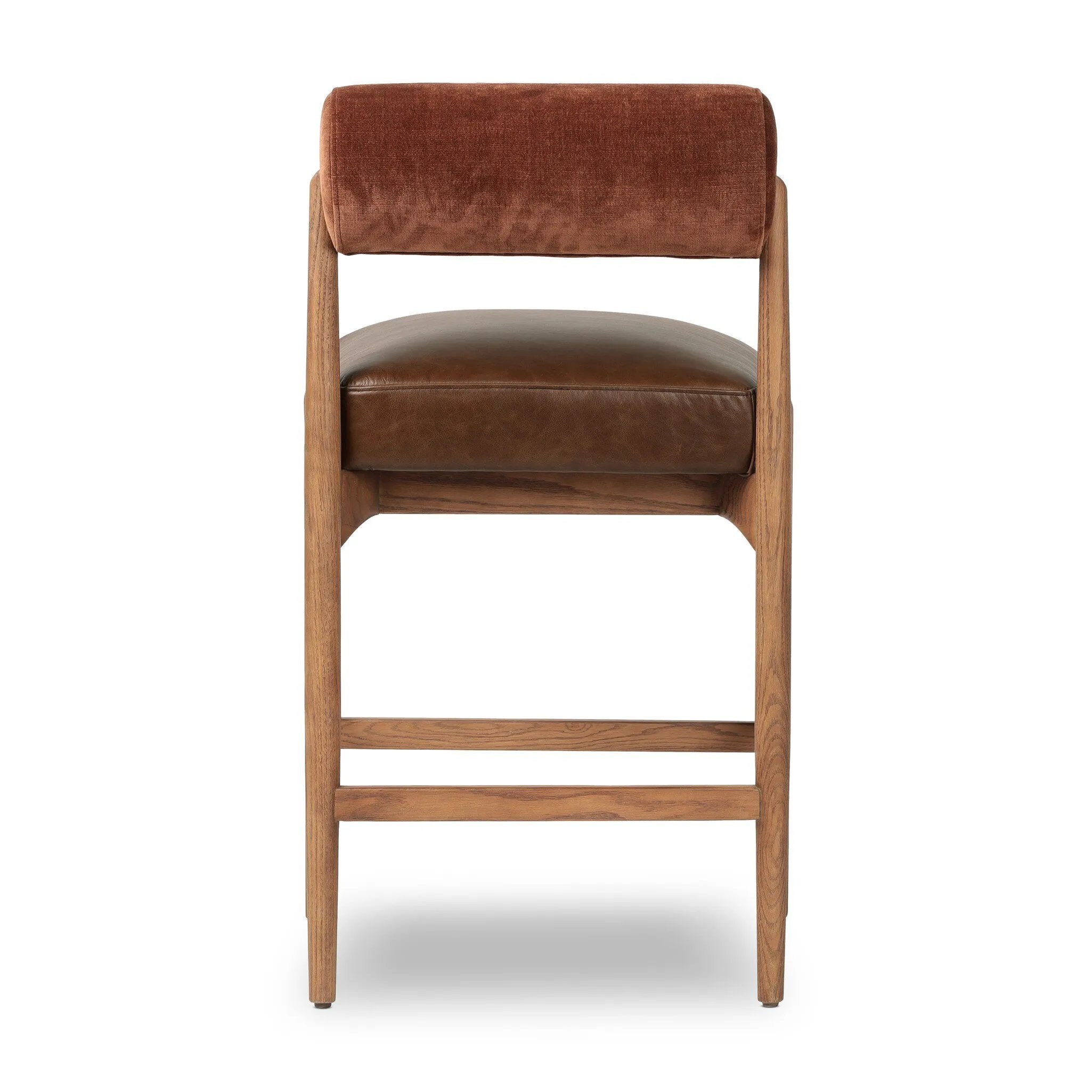 The classic counter stool gets a playful update with a bolstered cylinder seat back. Made from top-grain leather, velvet-like upholstery and warm-finished oak to elevate your bar, kitchen or dining space Amethyst Home provides interior design, new home construction design consulting, vintage area rugs, and lighting in the Tampa metro area.