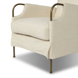 Bridging timeless tradition with modern edge, this upholstered chair strikes a one-of-a-kind silhouette. Its fixed, skirted slipcover and subtle winged back offer a classic feel, while a unique metal arm reveal  and slightly flared legs create an unparalleled look. Amethyst Home provides interior design, new home construction design consulting, vintage area rugs, and lighting in the Des Moines metro area.