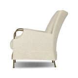 Bridging timeless tradition with modern edge, this upholstered chair strikes a one-of-a-kind silhouette. Its fixed, skirted slipcover and subtle winged back offer a classic feel, while a unique metal arm reveal  and slightly flared legs create an unparalleled look. Amethyst Home provides interior design, new home construction design consulting, vintage area rugs, and lighting in the Kansas City metro area.