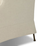 Bridging timeless tradition with modern edge, this upholstered chair strikes a one-of-a-kind silhouette. Its fixed, skirted slipcover and subtle winged back offer a classic feel, while a unique metal arm reveal  and slightly flared legs create an unparalleled look. Amethyst Home provides interior design, new home construction design consulting, vintage area rugs, and lighting in the Nashville metro area.