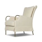 Bridging timeless tradition with modern edge, this upholstered chair strikes a one-of-a-kind silhouette. Its fixed, skirted slipcover and subtle winged back offer a classic feel, while a unique metal arm reveal  and slightly flared legs create an unparalleled look. Amethyst Home provides interior design, new home construction design consulting, vintage area rugs, and lighting in the Salt Lake City metro area.