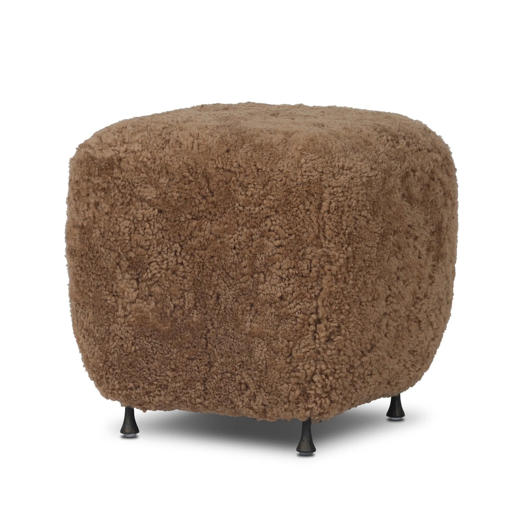 Small scale, big personality. This petite, shearling ottoman pairs a rounded upholstered seat with rugged, hammered black feet for a hand-crafted look.As lovers of modern materials at Amethyst, we love the nature inspired Joey Ottoman - Amber Shearling. This item pairs well with other brands such as Loloi Rugs and is perfect for coastal homes Amethyst Home provides interior design, new home construction design consulting, vintage area rugs, and lighting in the Tampa metro area.