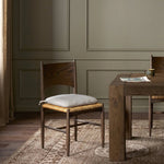 Featuring Jovan Savile Flax Dining Chair With Cushion by Four Hands at Amethyst Home. A seamless addition to your dining collection, a slim-profile dining chair pairs a woven banana leaf seat with a solid oak frame featuring a bentwood back. A tie-fasten seat cushion of high-performance fabric completes the look. Performance fabrics are specially created. Amethyst Home provides interior design, new home construction design consulting, vintage area rugs, and lighting in the Laguna Beach metro area.