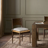 Featuring Jovan Savile Flax Dining Chair With Cushion by Four Hands at Amethyst Home. A seamless addition to your dining collection, a slim-profile dining chair pairs a woven banana leaf seat with a solid oak frame featuring a bentwood back. A tie-fasten seat cushion of high-performance fabric completes the look. Performance fabrics are specially created. Amethyst Home provides interior design, new home construction design consulting, vintage area rugs, and lighting in the Laguna Beach metro area.