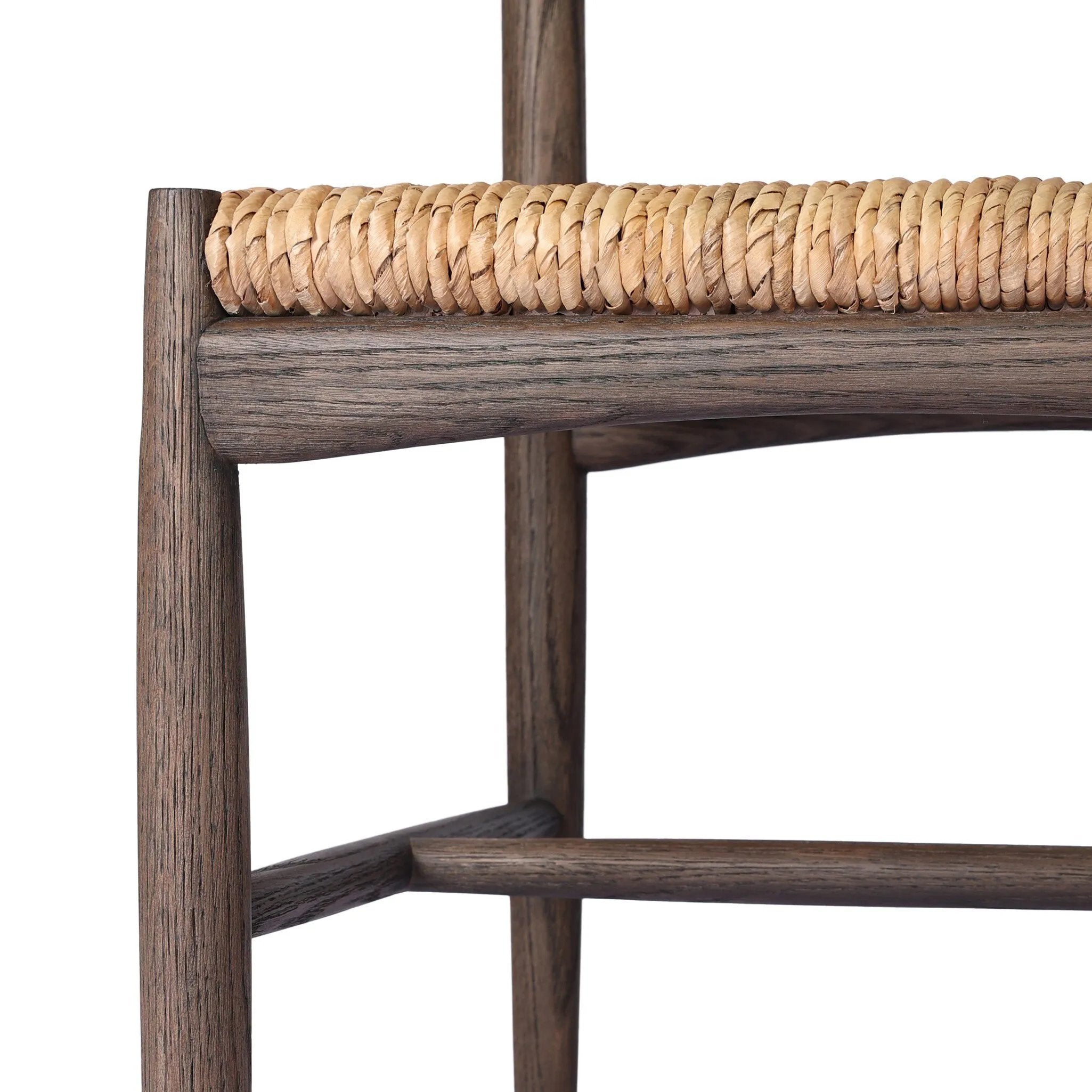 A seamless addition to your dining collection, a slim-profile dining chair pairs a woven banana leaf seat with a solid oak frame featuring a bentwood back Amethyst Home provides interior design, new home construction design consulting, vintage area rugs, and lighting in the Miami metro area.