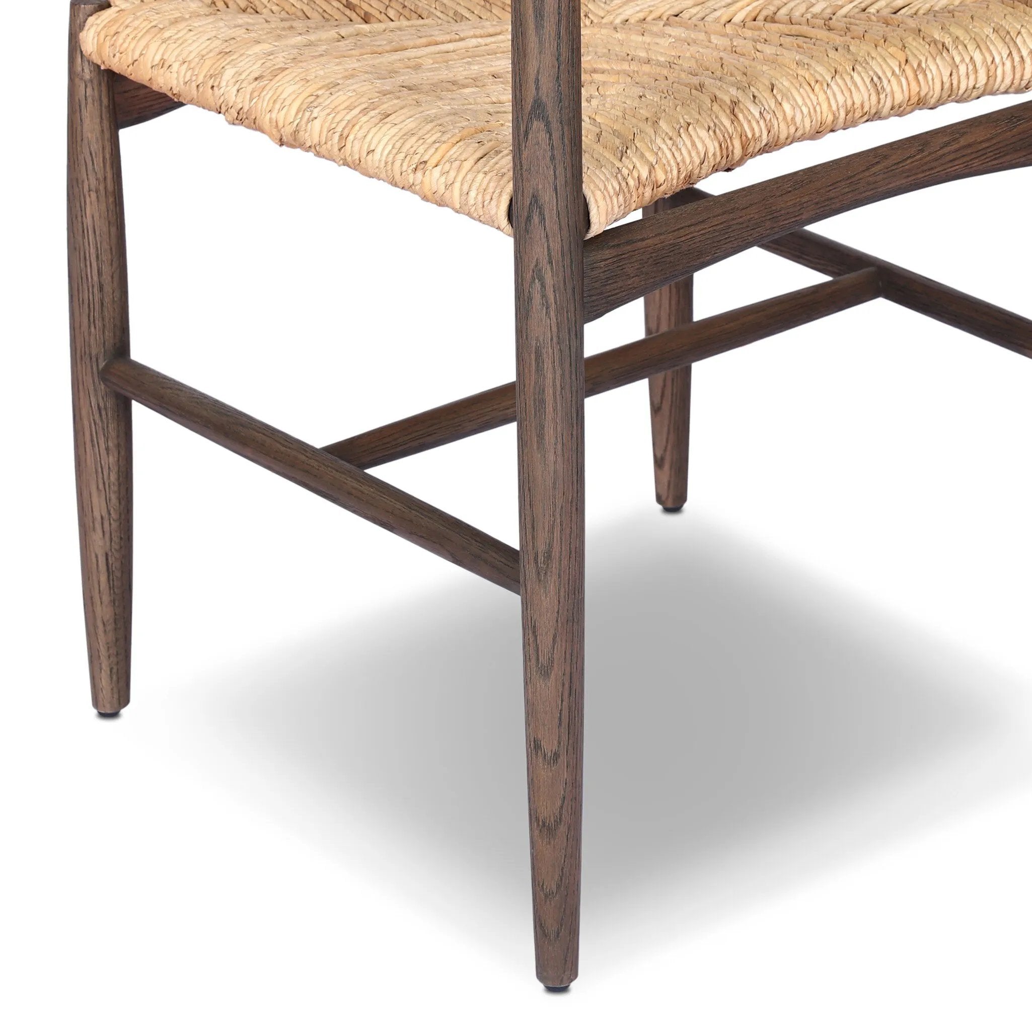 A seamless addition to your dining collection, a slim-profile dining chair pairs a woven banana leaf seat with a solid oak frame featuring a bentwood back Amethyst Home provides interior design, new home construction design consulting, vintage area rugs, and lighting in the Omaha metro area.
